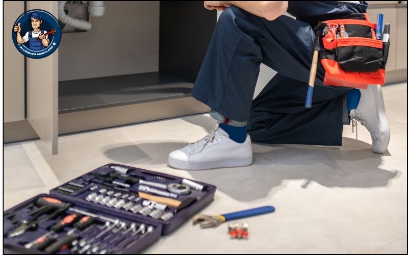 plumber with plumbing tools on the ground